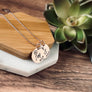 2 child charm pendant mother's necklace. one minimalist disc engraved with august flower, A initial, and 08.23.10. Second charm disc is March flower, letter S, and 03.20.12