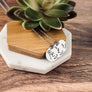 Silver 3 charm mothers necklace. each charm is engraved with the child's birth month flower, first name initial, and date of birth