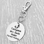 silver engraved stainless steel backpack tag keychain. engraved with a Rocket Image, Name Taityana. Teachers name Mrs. Smith. and Parent Pickup