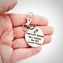 silver engraved stainless steel backpack tag keychain. engraved with a Rocket Image, Name Garrett Simon. Teachers name Mrs Haslem. Room number 154. and Parent Pickup