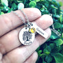 doula necklace on womens hand to show size
