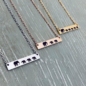 Mama Elephant with 3 babies engraved on silver bar necklace. Mama Elephant with 2 babies engraved on rose gold bar necklace. Mama Elephant with 5 babies engraved on yellow gold bar necklace