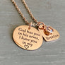 Rose Gold Necklace with 3/4 inch round pendant engraved with "God has you in his arms, I have you in my heart". Next to the disc is a 3/4 inch heart engraved with Brenton and a clear april stone. Pendants are attached to a cable chain