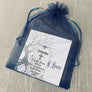 keychain packaged in a blue organza gift bag