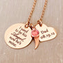 rose gold stainless steel 7/8" round disc engraved with "I used to be his Angel, now he's mine", an angel wing charm, a October pink birthstone, a 3/4" engraved heart with "Dad 08.19.12". all charms are attached to a rose gold stainless steel cable chain.
