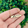 necklace on womans hand to show perspective