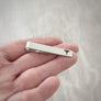medical caduceus symbol tie bar clip on woman's hand to show size
