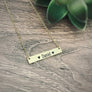 yellow gold horizontal bar necklace engraved with the children's name Daniel