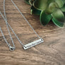 silver horizontal bar necklace engraved with the 3 children's names Nolan, Blair, Catarina