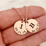 rose gold 2 disc pendant necklace with the initials I and B and date of birth engraved 3.11.19 and 6.25.21