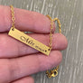 gold necklace on hand