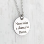.75 inch silver stainless steel round disc engraved with "never miss a chance to dance"