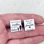 cufflinks in woman's hand to show size
