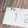bar necklace on ruler to show measurement