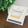 Yellow Gold horizontal "Relentless" morse code necklace on packaging card