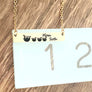 bar necklace on ruler to show measurements