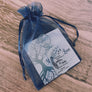 keychain wrapped in blue organza gift bag