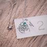 necklace on a ruler to show 1" size disc