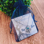 necklace packaged in blue organza gift back from stamps of love