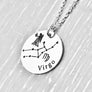 silver stainless steel 7/8" disc engraved with Virgo, its constellation, symbol, and the Maiden. attached to a stainless steel cable chain with lobster clasp