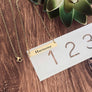 bar necklace on ruler to show measurement