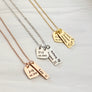 rose necklace with heart engraved "J + N est 2012" and 1 rectangle name tag with the taurus zodiac sign and name Leo. Silver necklace with "C + J ext 2001" and 2 name tags "Regan and gemini sign, Kelsey and a virgo sign. Gold necklace "C +. B est 2012" Jocelyn Aries symbol, Rowan Capricorn, Finley Sagittarius zodiac symbol