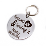 Silver stainless steel dog collar id tag with black engraving "Rescued & Loving it" with a picture of a heart with a dog paw inside, pets name and telephone number