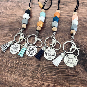 5 teacher lanyard colors and charm tags. best teacher ever, teach love inspire, and name only tags in black, mint green, orange, and coral