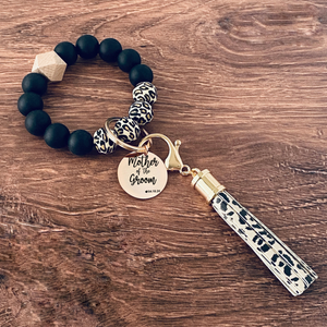 Cheetah, Marble and grey silicone beaded wristlet with matching lobster clasp leather tassel. Attached a large stainless steel circle charm tag engraved with Mother of the Groom, a small heart silhouette  and the wedding date 4.18.24