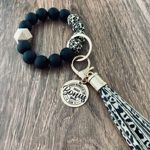 cheetah print with black round silicone beaded keychain wristlet with rose gold charm tag engraved with "proud member of the badass bonus mom club"