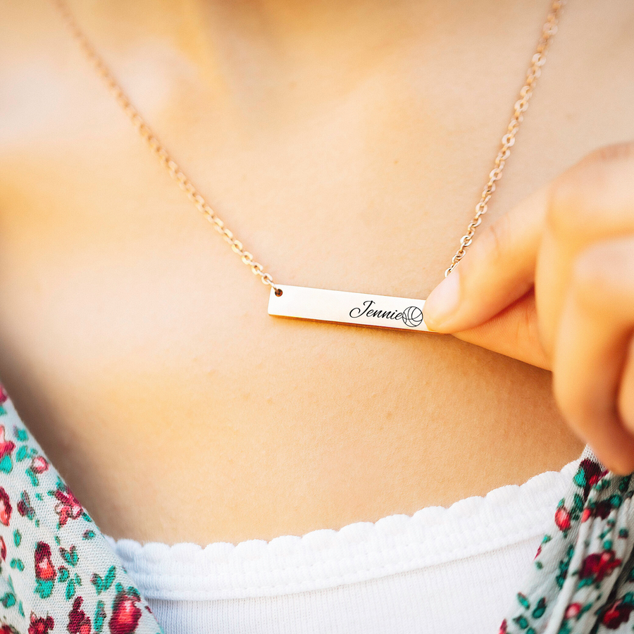 Engraved rose gold bar necklace engraved and customized with the athlete’s name Jennie and a basketball image