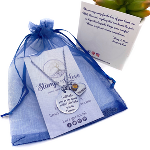 necklace shown in packaging with blue organza gift bag