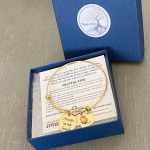 bracelet shown in a blue jewelry gift box