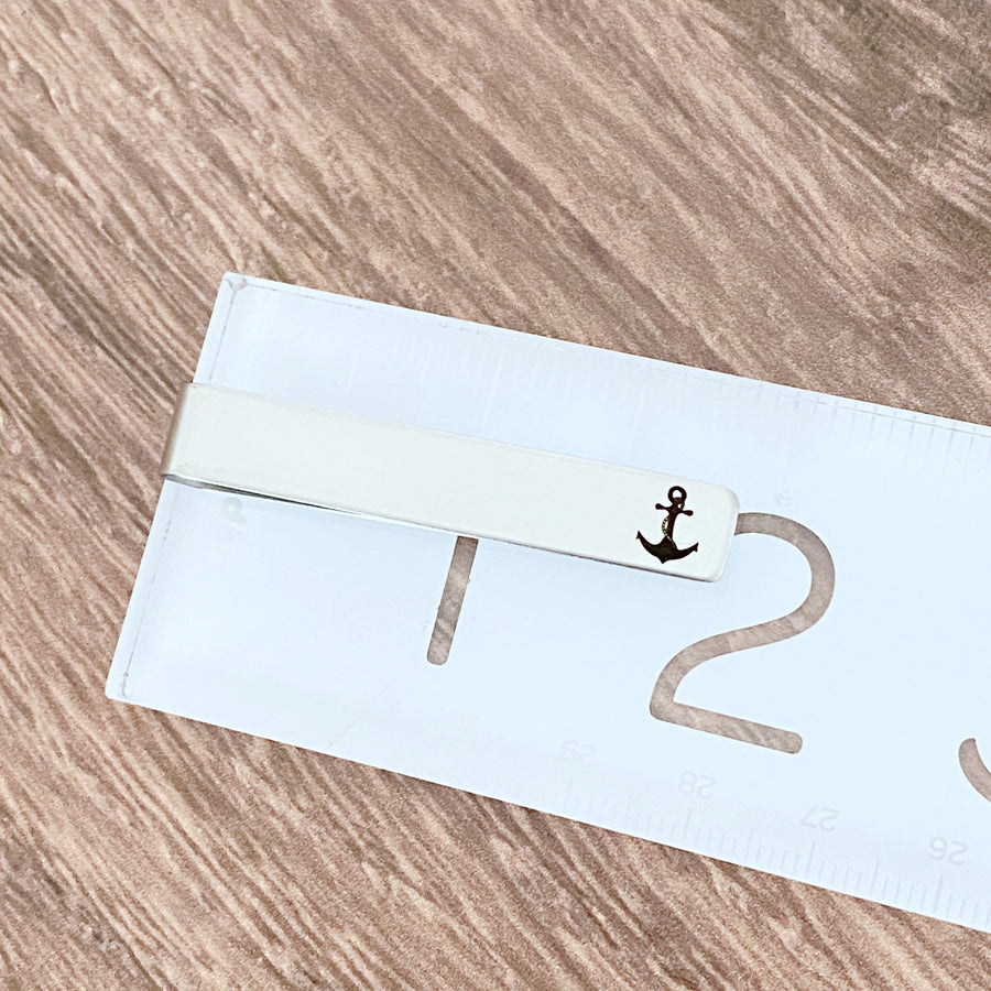 anchor tie clip on ruler to show length of 2"