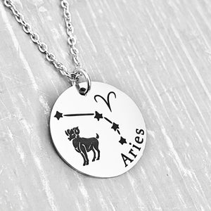 silver stainless steel 7/8" disc engraved with Aries, its constellation, symbol, and the Ram. attached to a stainless steel cable chain with lobster clasp