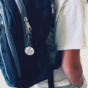 boy wearing backpack with id tag