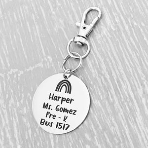silver engraved stainless steel backpack tag keychain. engraved with a Rainbow Image, Name Harper. Teachers name Ms. Gomez. Pre-K. and bus 1517
