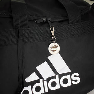 football bag custom id tag engraved with the name Bentley attached to a sports bag.