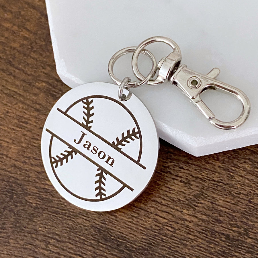 Round shiny silver stainless steel keychain engraved with a baseball and the name Jason. Keychain is attached to lobster clasp key hook.