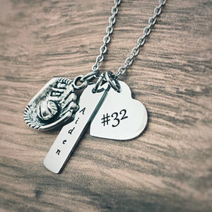 baseball glove charm, rectangle name charm engraved with the name Aiden, and a heart charm engraved with the jersey number 32