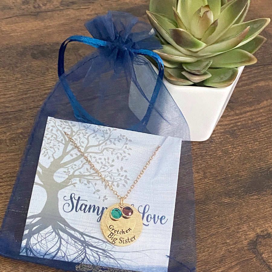 necklace packaged in a blue organza gift bag