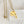 yellow gold necklace on ruler to show measurements