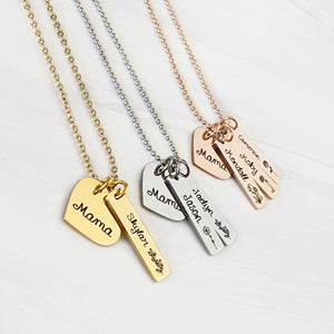 yellow gold, silver, and rose gold necklaces with a heart charm engraved with "mama". rectanagle tags are engraved with child's name and birth month flower