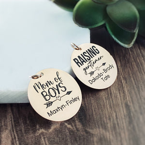 2 personalized wristlet charm tags engraved with "mom of boys" and boys names maxtyn and finly. other tag "raising gentlemen" with names dakoda, brody, tate