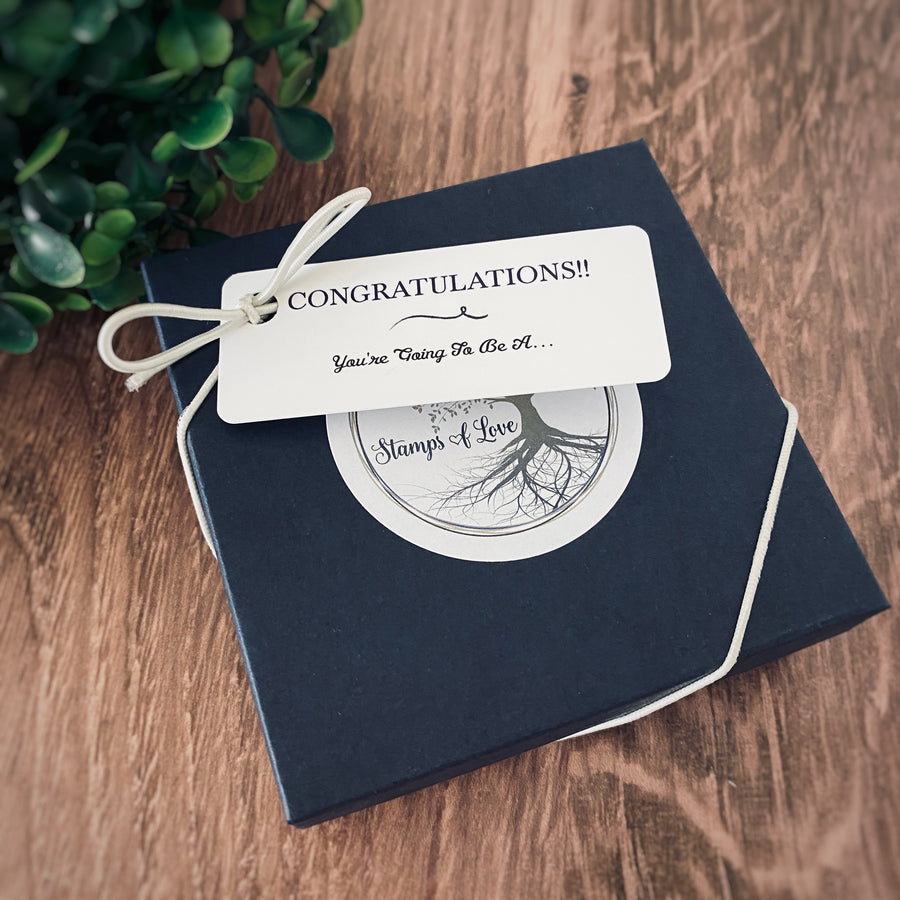 Stamps of Love pregnancy announcement gift box with a "Congratulations!! You're Going to be a..." gift box tag