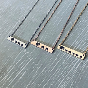 Mama Elephant with 3 babies engraved on silver bar necklace. Mama Elephant with 2 babies engraved on rose gold bar necklace. Mama Elephant with 5 babies engraved on yellow gold bar necklace