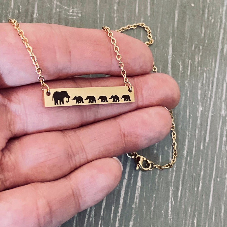 Mama Elephant with 5 babies engraved on yellow gold bar necklace.