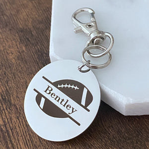 football bag tag engraved with the name bentley attached to a keychain lobster hook
