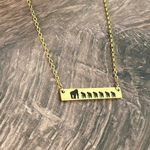 yellow gold gorilla bar necklace with 1 mom gorilla and 6 engraved baby gorillas 