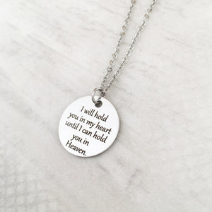 One 1-inch silver stainless steel disc engraved with "I will hold you in my heart until I can hold you in Heaven" The pendant is attached to a stainless steel cable chain with lobster clasp.